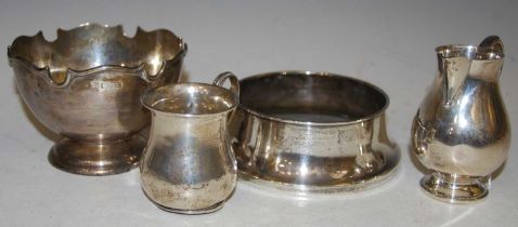 A collection of silver to include; a London sparrow beak cream jug, a London christening mug