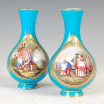 A pair of 18th century Sèvres bleu-celeste ground bottle vases, both decorated with two oval