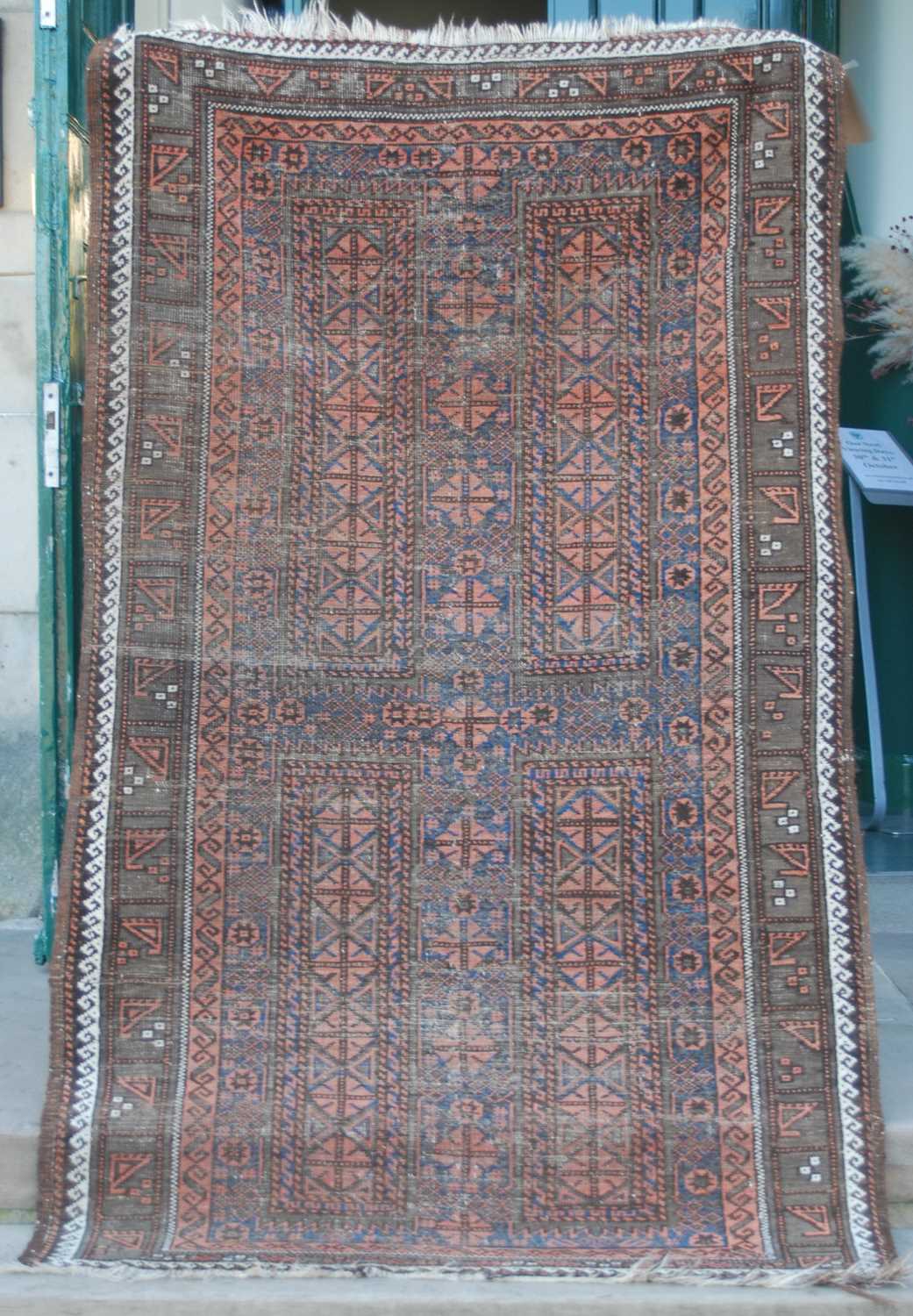 A Persian rug, early 20th century, the rectangular field centred with a cross form motif worked in