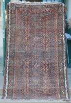 A Persian rug, early 20th century, the rectangular field centred with a cross form motif worked in