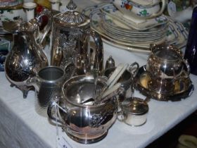 A collection of EPNS and pewter items to include water jugs, cream jug, twin-handled sugar bowls,