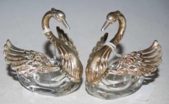 A pair of Continental silver mounted cut glass table swans with hinged and pierced wings, stamped