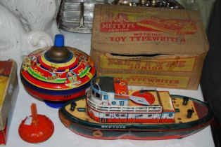 A collection of vintage tin plate toys comprising a boxed 'Mettype' junior working toy typewriter, a