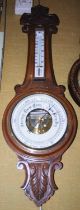 A late 19th century oak aneroid barometer with white coloured dial, 90cm long.