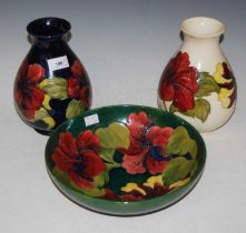 A Moorcroft pottery vase, decorated with hibiscus on a white ground, impressed marks and remains