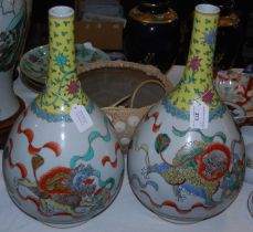 A pair of Chinese porcelain bottle vases, 20th century, with lotus and Shishi decoration, 45cm high.