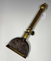 Equestrian interest: an antique copper and brass horse hair singeing tool.