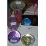A group of assorted glassware comprising three Caithness Glass paperweights, another paperweight,