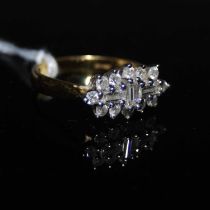 An 18ct gold and diamond cluster ring, ring size P, gross weight 5.5 grams, set with one baguette