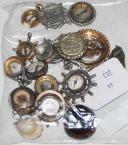 A collection of assorted pocket watch fobs with compass inserts