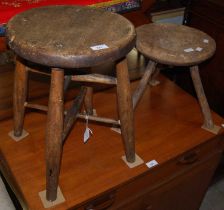 A vintage oak milking stool, together with a vintage oak stool raised on four supports united by