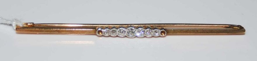 An early 20th century yellow and white metal seven stone diamond set bar brooch (two small