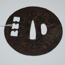 An antique Japanese cast iron Tsuba, approximately 8cm diameter.