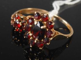 Two 9ct gold and garnet flower cluster rings, gross weight 6.1 grams.