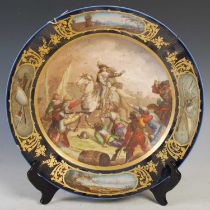 A late 19th/ early 20th century Sevres style bleu du roi ground porcelain charger decorated with a