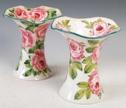 A pair of Wemyss Pottery Lady Eva vases, decorated with roses, one with yellow painted 'Wemyss' mark