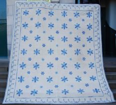 An embroidered wall hanging of large proportions, the off-white ground decorated with blue