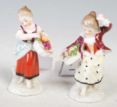 A pair of late 19th / early 20th century continental porcelain figures of girl flower picker and