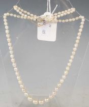 A vintage graduated pearl necklace with diamond set flower clasp.