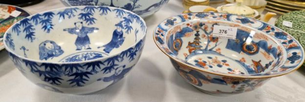 A Japanese blue and white bowl decorated with male figures, together with a Chinese Imari palette