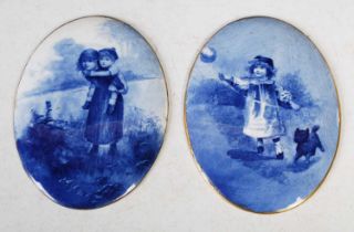 A pair of late 19th century Doulton blue printed oval porcelain plaques, one decorated with girl