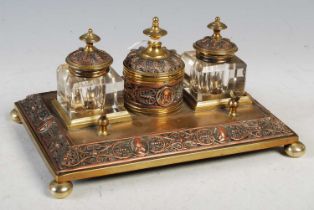 A late 19th century brass and copper embossed desk stand.
