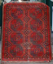A Persian rug, early 20th century, the shaped rectangular orange ground decorated with angular