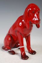 A Royal Doulton Flambe glaze model of a seated bloodhound, 14.5cm high.