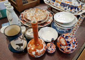 A collection of Chinese and Japanese ceramics to include Imari pattern plates and bud vase,