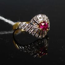 A yellow and white metal ruby and diamond set cocktail ring, set with one round faceted ruby