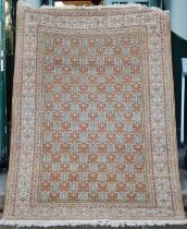 A Persian rug, 20th century, the burnt orange rectangular field decorated with multiple sails of
