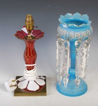 A late 19th century opaque white overlaid ruby glass table lamp with gilded decoration and