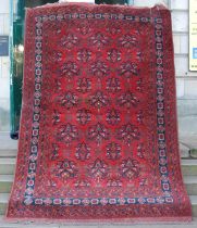 A Persian carpet, mid 20th century, the rectangular field decorated with urn shaped motifs enclosing