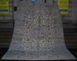 A Persian Kashan carpet, 20th century, the rectangular ivory coloured ground centred with a large