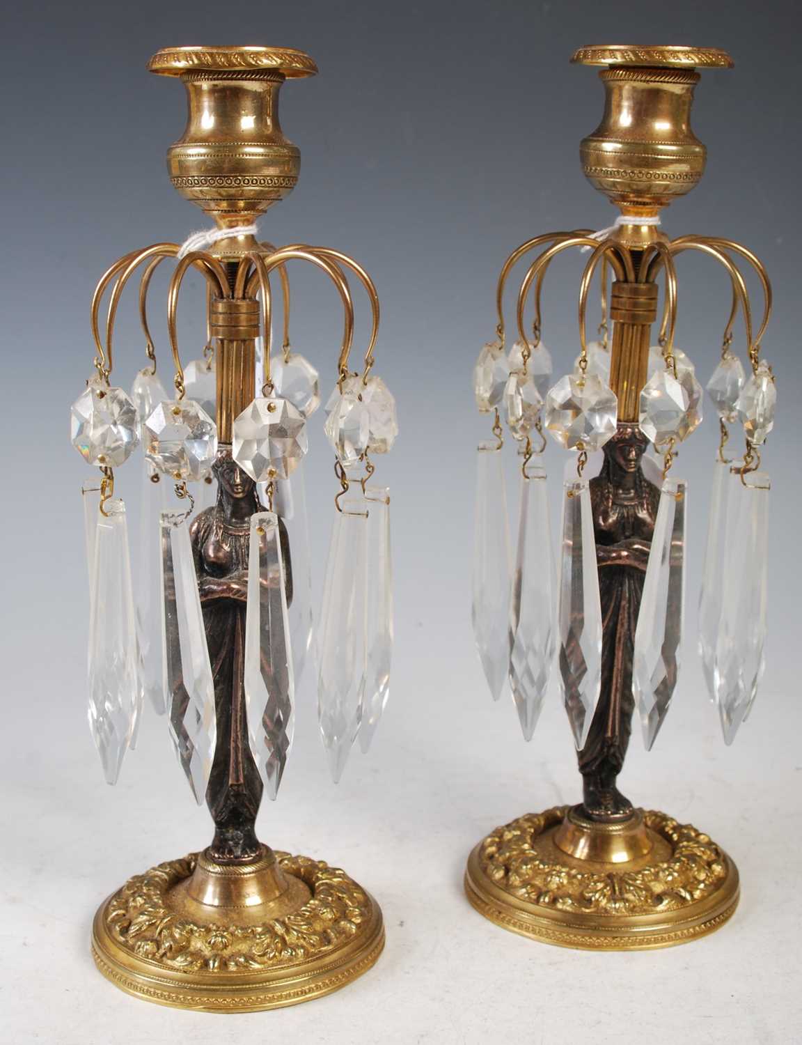 A pair of 19th century Regency style gilt metal and cut glass lustre candlesticks, each with