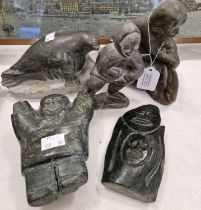 A group of Inuit stone carvings to include a figure wearing a hooded jacket, inscribed on base '