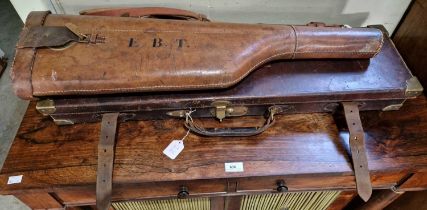 An antique leather gun case, the underside of the lid with retailer's paper label for 'William