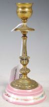 A brass and porcelain mounted candlestick, late 19th century, 15cm high.