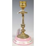 A brass and porcelain mounted candlestick, late 19th century, 15cm high.