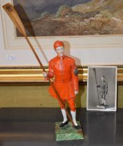 A porcelain figure of a waterman, Doggett Winner, wearing coat and badge, likely to be produced by