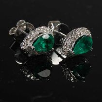 A pair of Art Deco style white metal, emerald and diamond set pear-shaped cluster earrings, set with