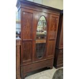 An Edwardian mahogany single door wardrobe, with satinwood inlaid details, the single door with oval