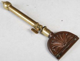 Equestrian interest: an antique copper and brass horse hair singeing tool.