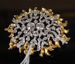 A yellow and white metal diamond set abstract brooch, unsigned, possibly John Donald, in a brown