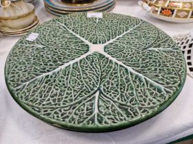 A pair of pottery plates, in the form of a cabbage leaves in relief.