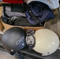A collection of vintage motorcycle equipment to include two vintage helmets, a set of vintage