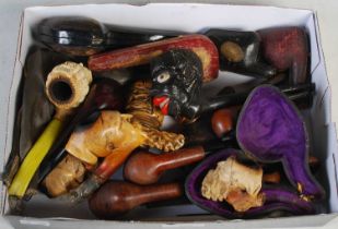 A box containing assorted meerschaum and other smoking pipes, some boxed and unboxed examples.