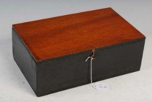 A mahogany box containing metal chess pieces painted black and white, probably 20th century.