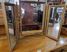 A gilt framed triple plate dressing table mirror.