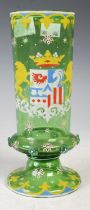 A Continental green glass goblet with blue, white, red and yellow enamelled decoration and applied